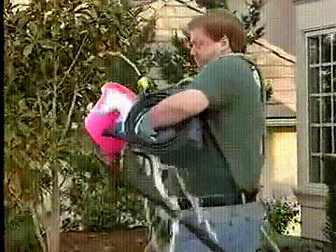 Animated GIF Of Man Struggling To Hold Hose And Soap Bucket Outdoors